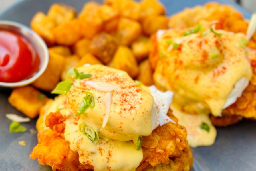 image of eggs benedict on fried chicken with potatoes